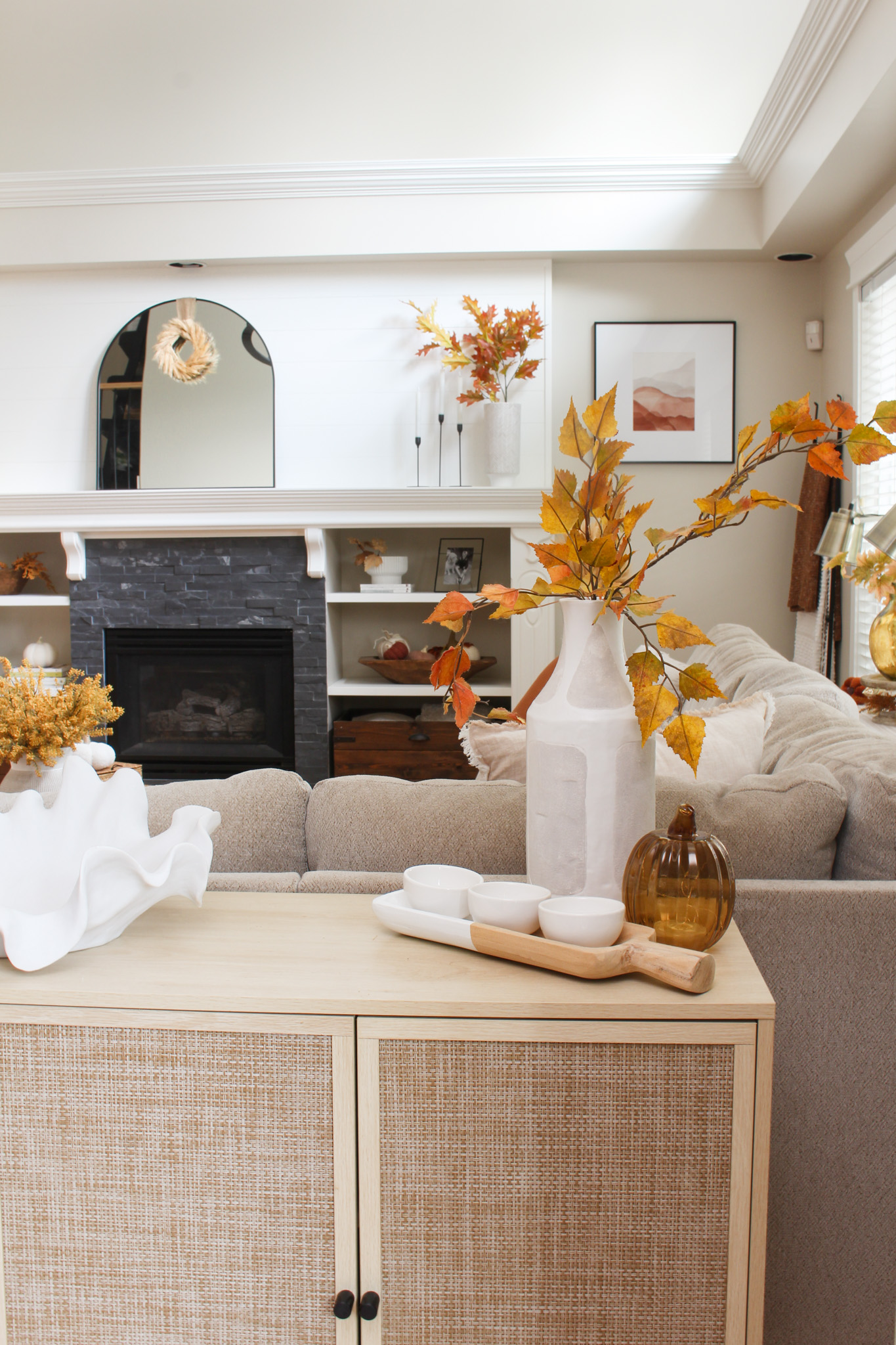 Living room with fall floral arrangement and neutral décor