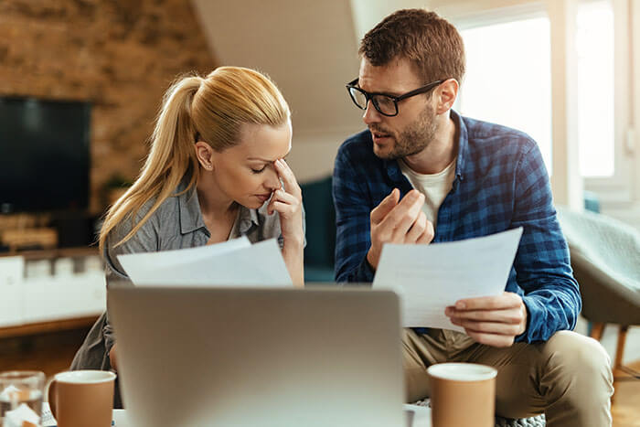 young couple discussing insurance after hurricane